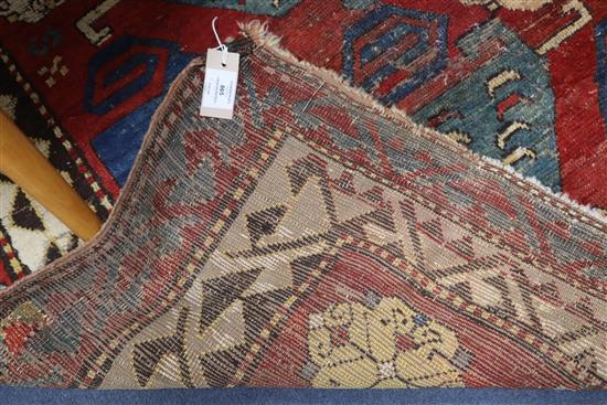 A Caucasian brick red ground rug 208 x 170cm